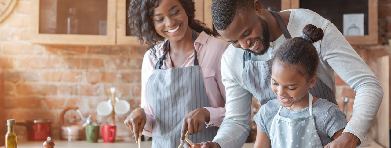 Family cooking together and smiling